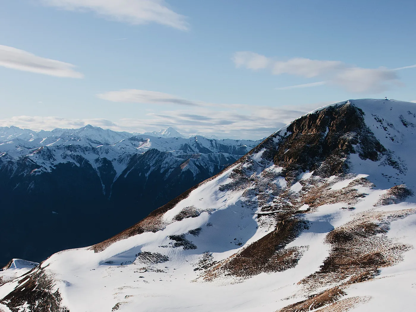Sunlit snow-covered mountain ridges in winter